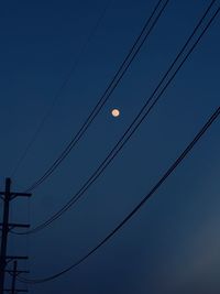 Low angle view of electricity pylon against sky