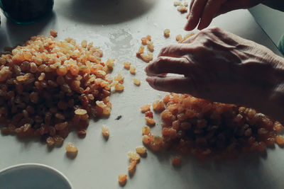 Close-up of person preparing food on table