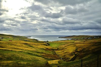 Scenic view of landscape against cloudy sky