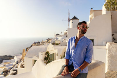 Man standing by sea against sky