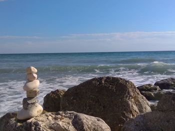 Rocks on beach against sky