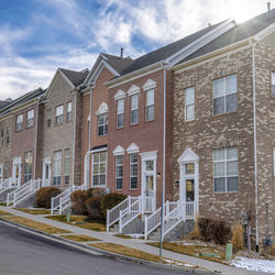 Buildings by street against sky