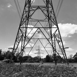 Low angle view of electricity pylon against sky