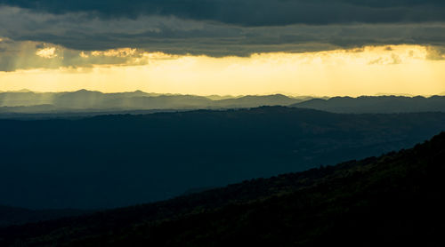 Scenic view of silhouette mountains against sky during sunset