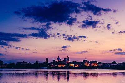 View of city at waterfront during sunset