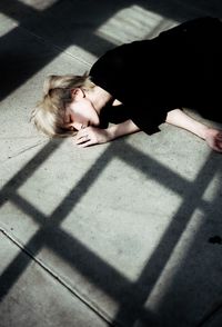 High angle view of woman lying down on floor