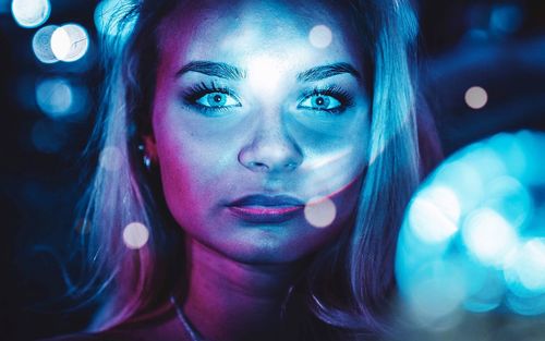 Close-up portrait of beautiful young woman at disco 
