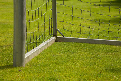 Soccer goal on field seen through fence