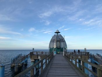 Pier over sea against sky