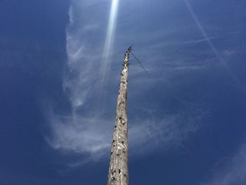 Low angle view of vapor trail against blue sky