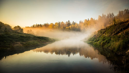 Scenic view of lake against sky during sunset