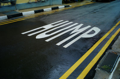 High angle view of arrow sign on road in city