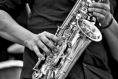 Close-up of man playing trumpet outdoors