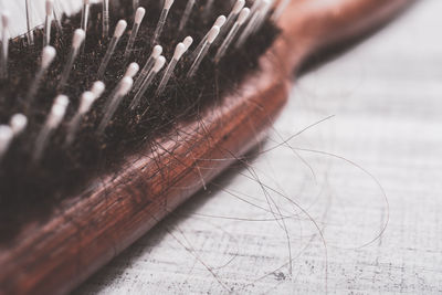 Close-up of hair in brush on table