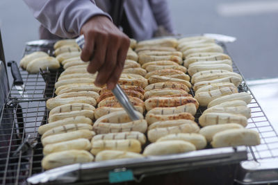 Grilled bananas are sold and prepared on the streets