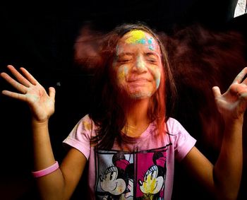 Midsection of man wearing multi colored hair against black background