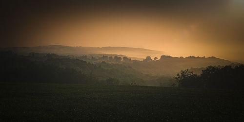 Scenic view of field against sky during sunset