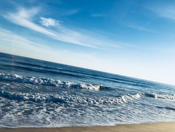 Scenic view of sea against blue sky