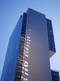 Low angle view of modern building against clear blue sky