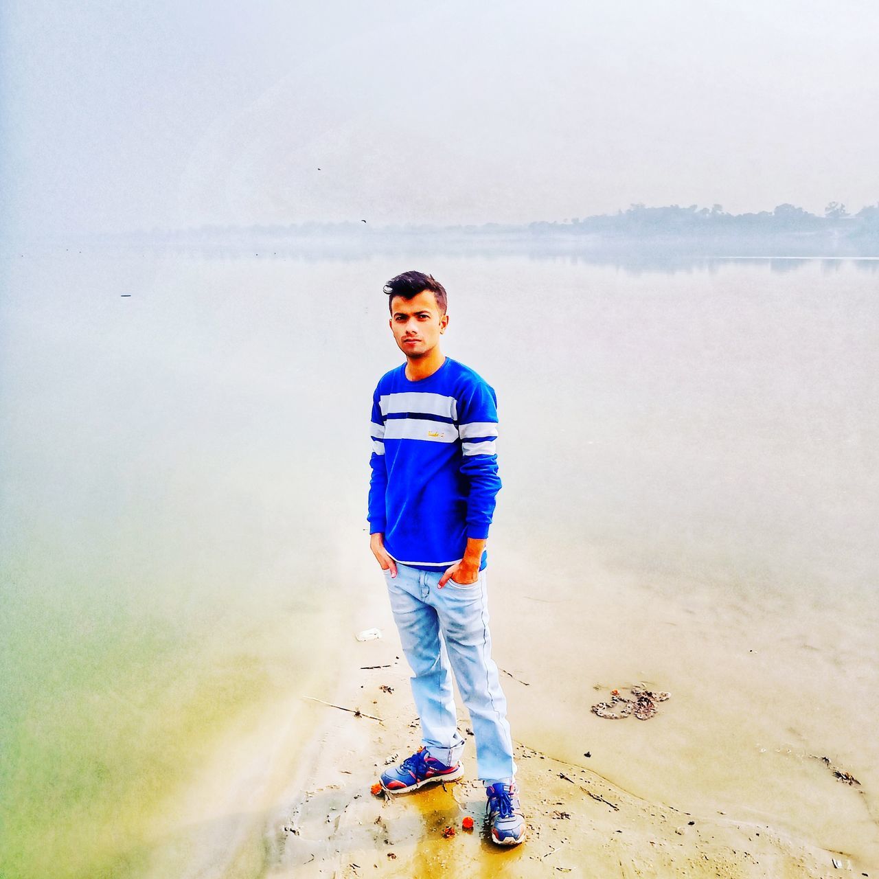 MAN STANDING ON BEACH