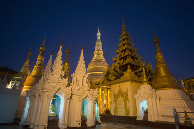 Shwedagon pagodas against clear blue sky at dusk