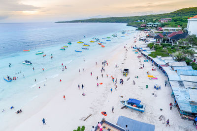 High angle view of people at beach during sunset