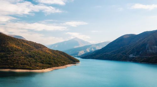 Scenic view of lake and mountains against sky