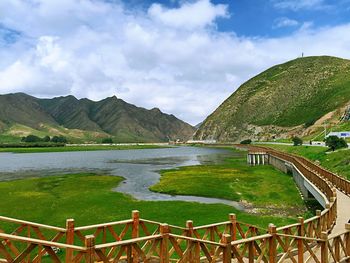 Scenic view of lake and mountains against sky