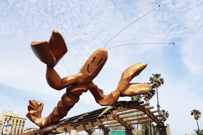 Low angle view of sculpture on tree against sky