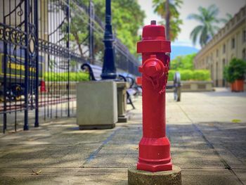 Red fire hydrant on footpath in city