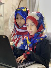 Online learning has become a new norm nowadays and a potrait shows two girls are   looking at laptop