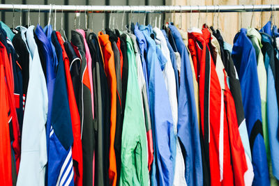 Multi colored flags hanging on rack in store