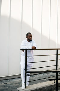 Side view of man sitting on bench