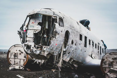 Abandoned airplane against sky