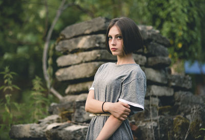 Portrait of young woman standing outdoors