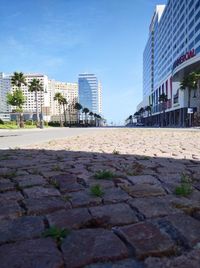 Surface level of street by buildings against sky