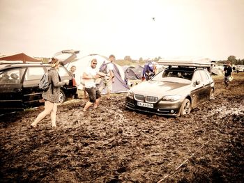 Panoramic view of damaged cars against sky