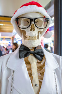 Close-up of person wearing mask and santa hat