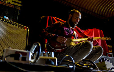 Man playing guitar in a rehearsal room