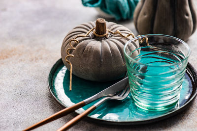 Autumnal table setting with leaves and pumpkin on wooden table