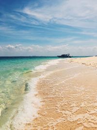 View of beach against cloudy sky