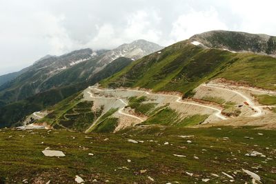 Scenic view of green mountains against sky