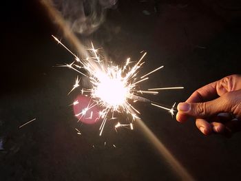 Low angle view of firework display at night