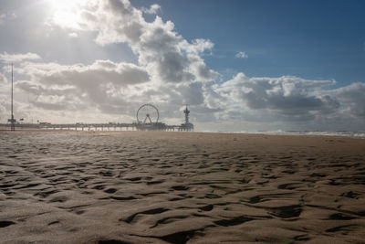 Low angle view of pier of scheveningen with ferris wheel and bungee tower, the netherlands