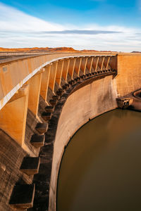 Arch bridge against cloudy sky