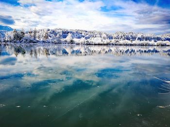 Scenic view of lake against sky during winter