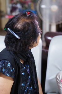 Rear view of woman sitting outdoors