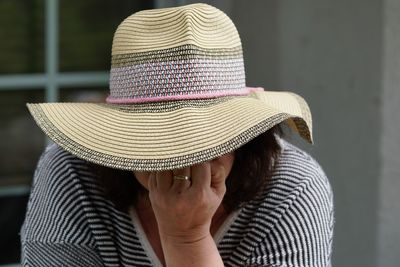 Close-up of woman wearing sun hat