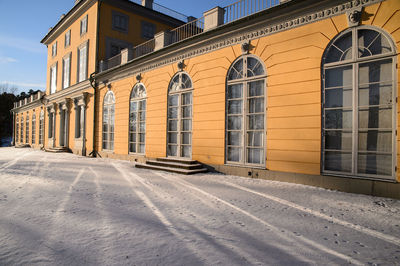 Street by building in city during winter