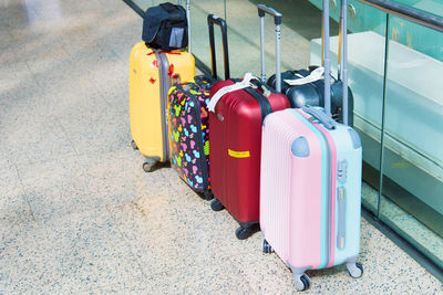 Suitcases by glass at airport